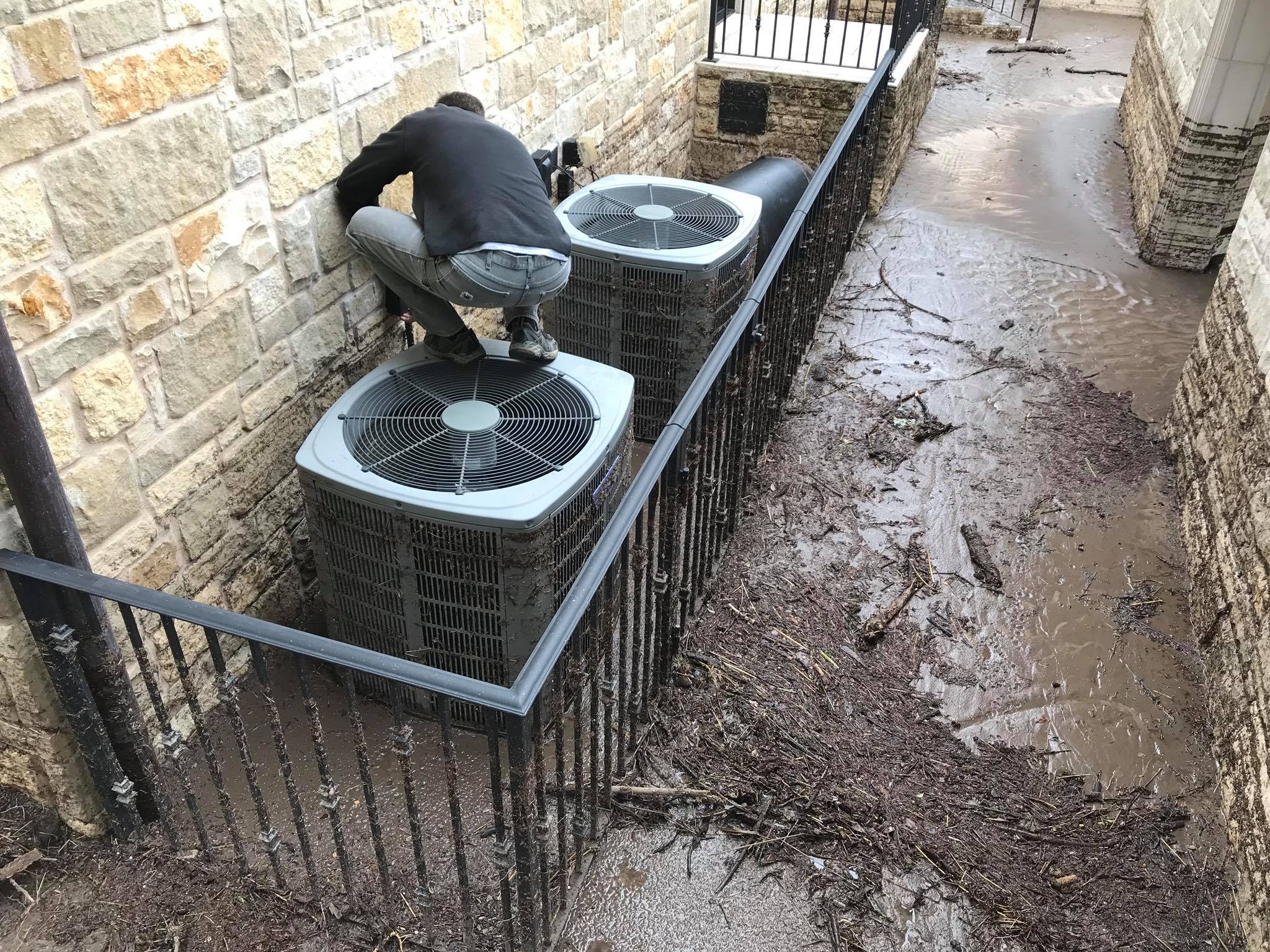 Rheem commercial rooftop HVAC unit being serviced with manifold gauges and refrigerant by Highland Lakes Heating & Air — commercial AC repair Marble Falls TX